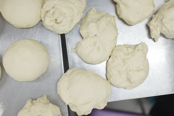 Pieces of dough lying on a steel table top — Stock Photo, Image