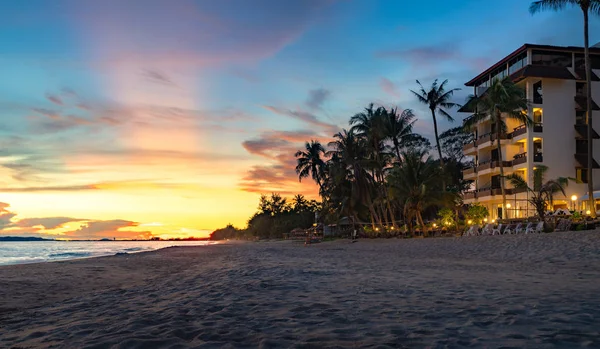 Rayong beach with sunset and resort background, coconut palm and hotel on the beach in summer, Rayong city, Thailand