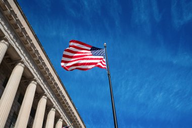 American flag with blue sky background and building mall, Washington DC, USA clipart