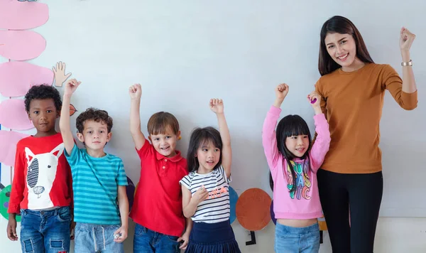 Lehrer und Schüler in einer internationalen Vorschule stehen zusammen — Stockfoto