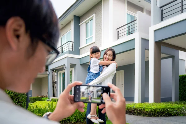 Vackra familjeporträtt leende utanför deras nya hus — Stockfoto