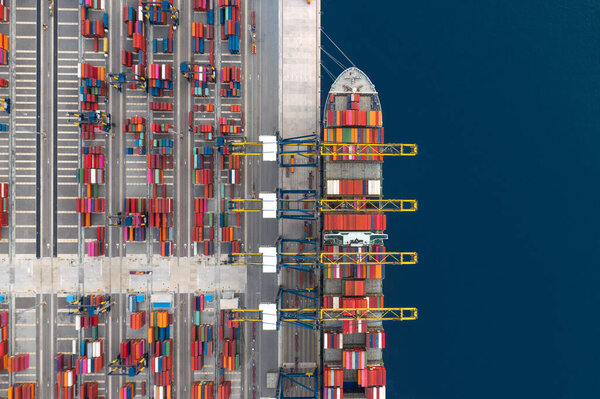 Container cargo ship loading at port, Freight transportation import export and business logistic by container ship, Aerial view.