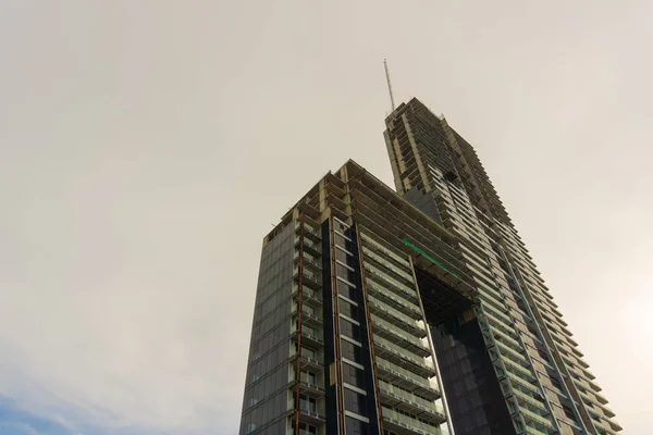 A big,unfinished apartment building near Bali Hai in Pattaya,shot from a public place