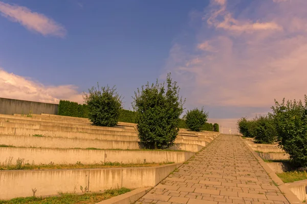 An outdoor relaxing area below a cloudy summer sky