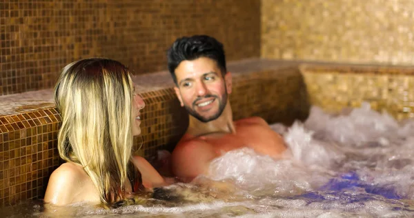 couple doing a whirlpool bath in a spa