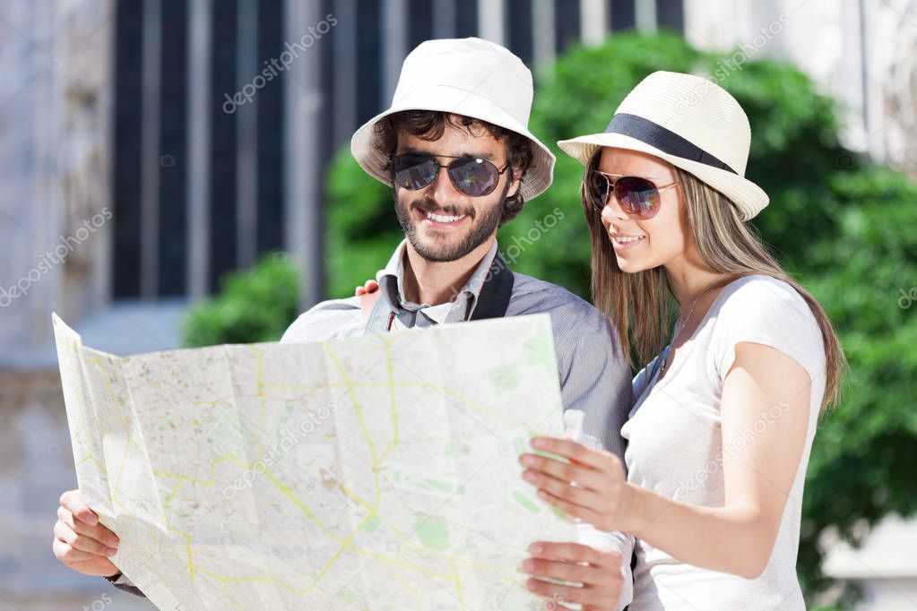 Couple of young tourists reading a map