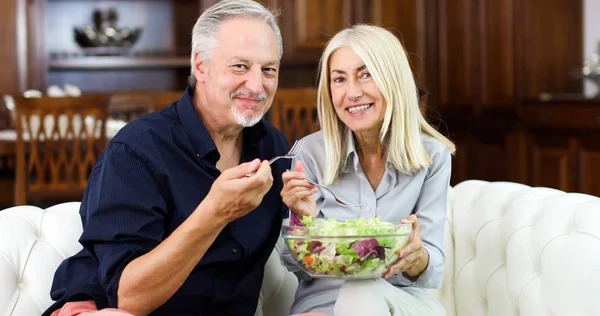 Senior couple eating a salad