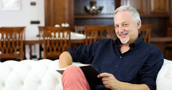 Mature Man Relaxing While Reading Book Sofa Home — Stock Photo, Image