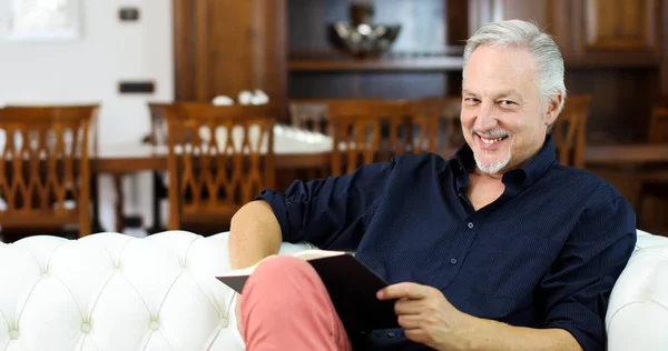 Mature Man Relaxing While Reading Book Sofa Home — Stock Photo, Image