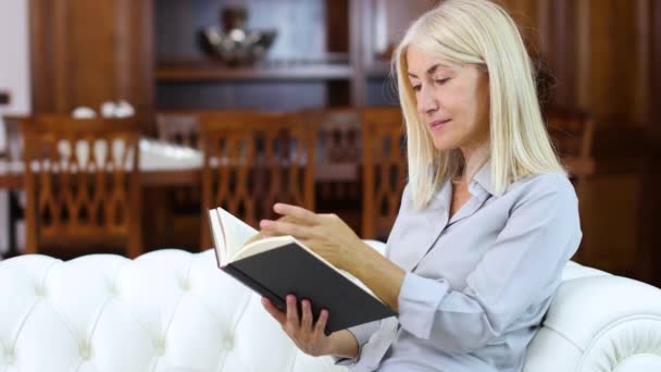 Mature Woman Relaxing While Reading Book Sofa Home — Stock Video