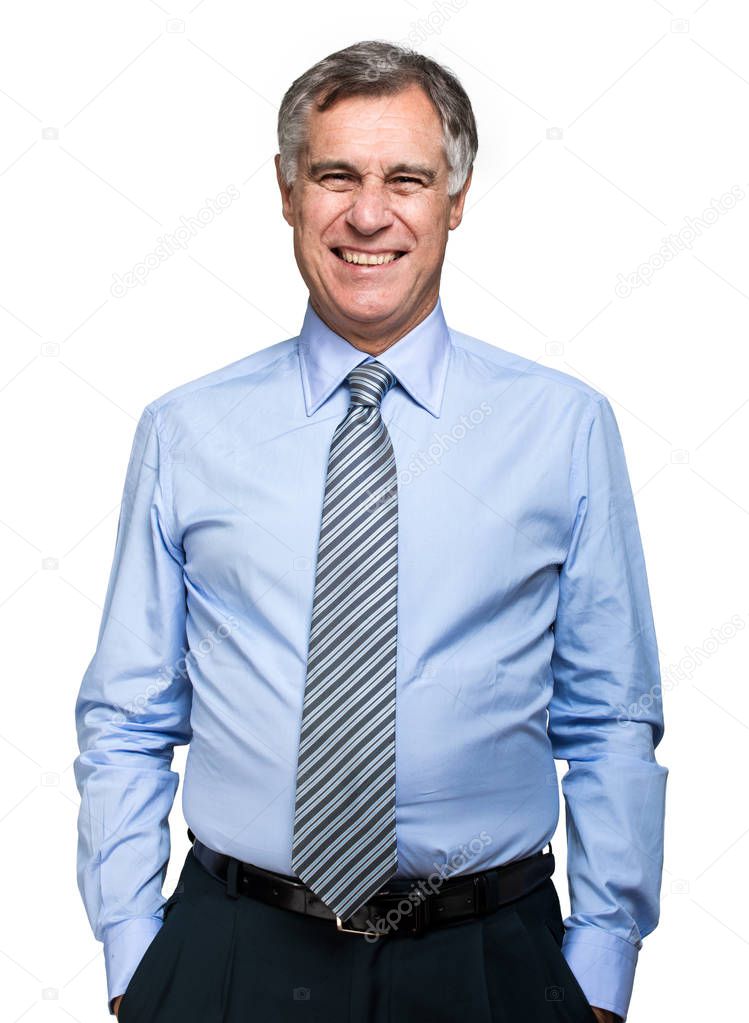 confident mature businessman with hands in the pockets 