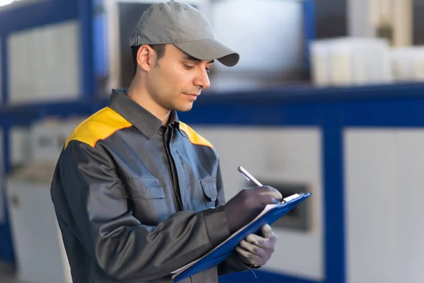 Pensive Industrial Worker Writing Document — Stock Photo, Image