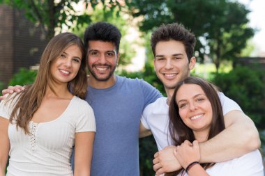 Sarılma ve kameraya bakarak arkadaş grubu 