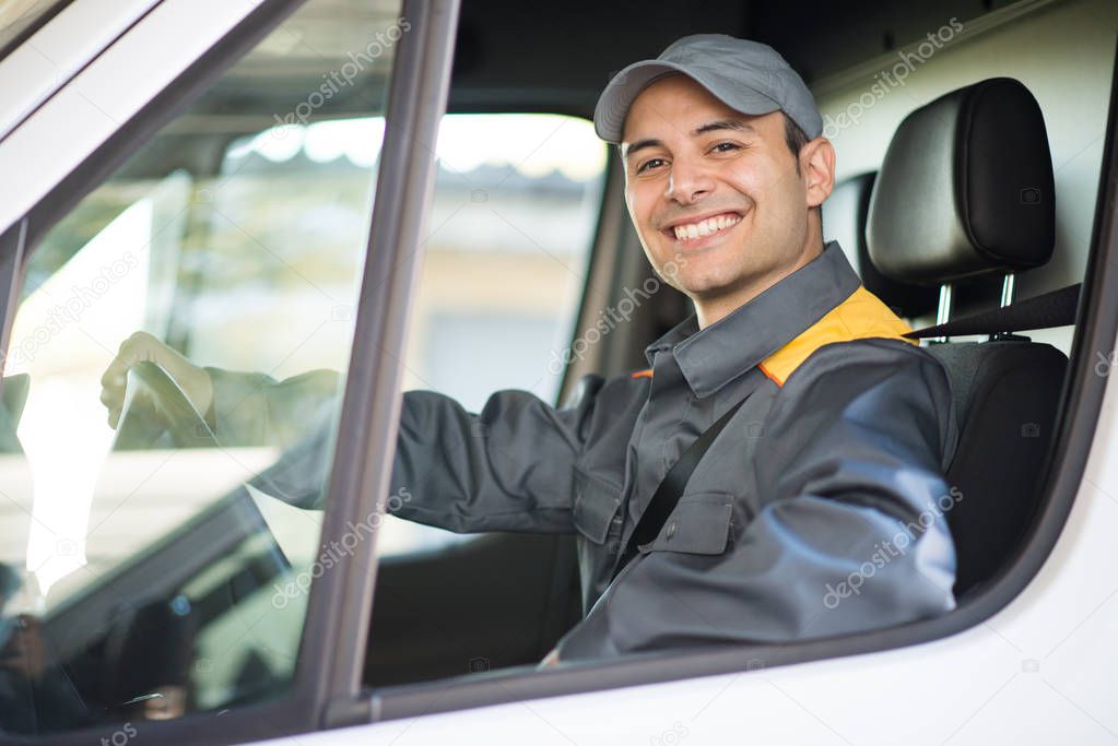 Smiling deliverer driving van
