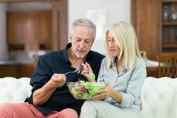 Disgusted couple eating salad