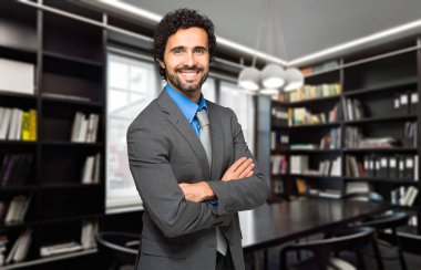 Young businessman in his studio clipart