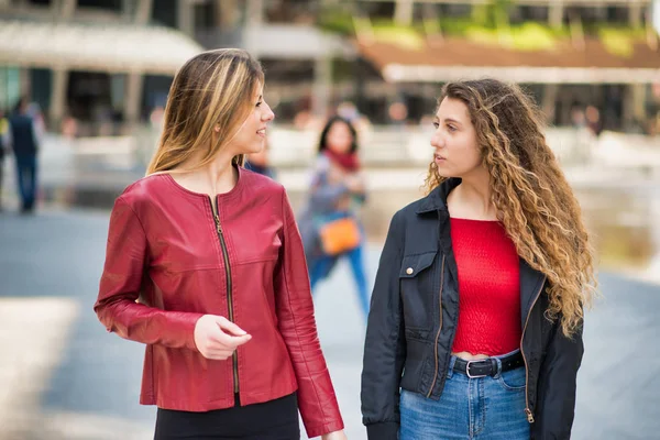 Female friends meeting in a city