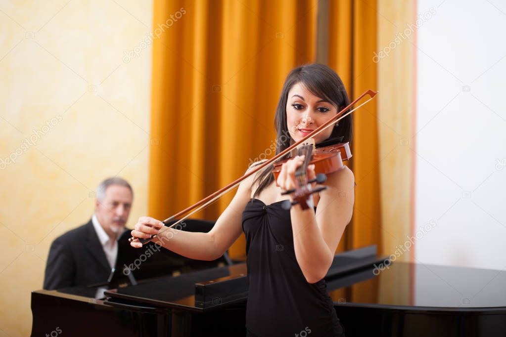 Young musician woman playing her violin