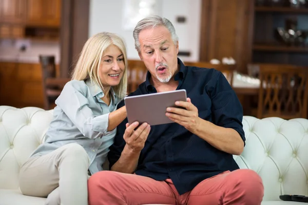 Pareja Madura Usando Una Tableta Digital Sofá Casa —  Fotos de Stock