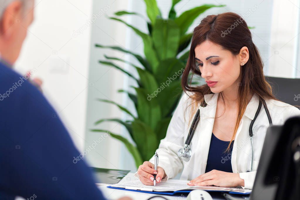 Doctor examining a radiography with her patient