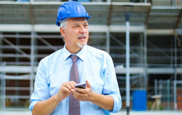 Senior Mérnök Segítségével Smartphone Kültéri Egy Építkezésen — Stock Fotó