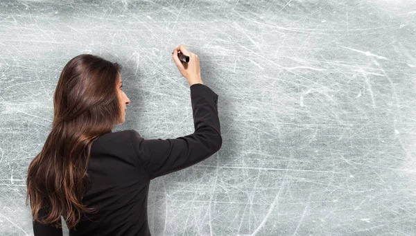 Zakenvrouw Schrijven Tegen Een Grijze Achtergrond — Stockfoto