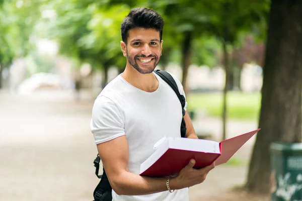 Smiling male student in park