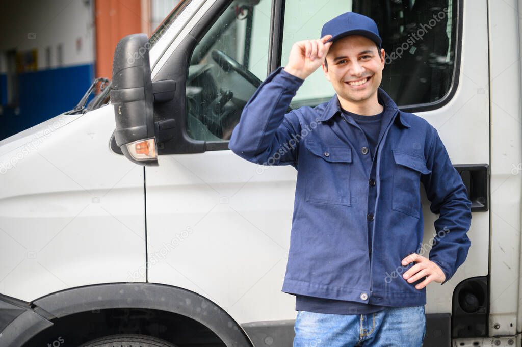 Portrait of a driver standing near his van and smiling