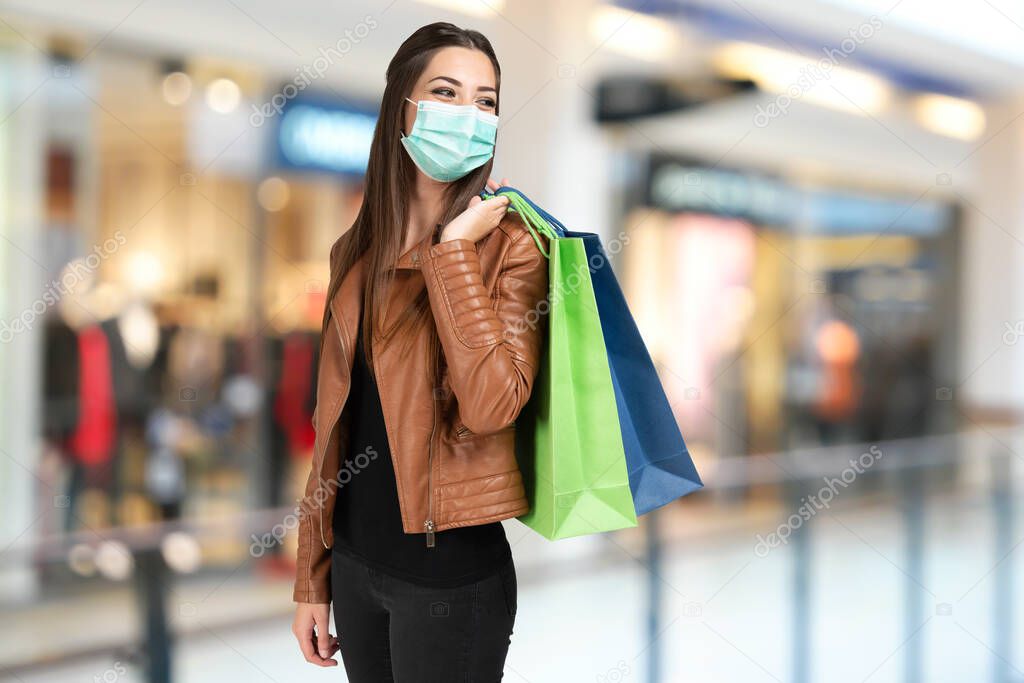 masked woman with shopping bags