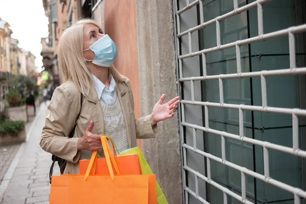 Angry and surprised customer in front of a shop closed due to coronavirus pandemic