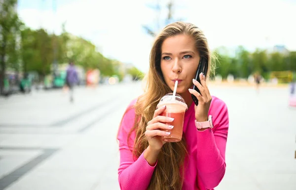 Glückliche Junge Frau Trinkt Draußen Einen Kaffee Während Sie Telefoniert — Stockfoto
