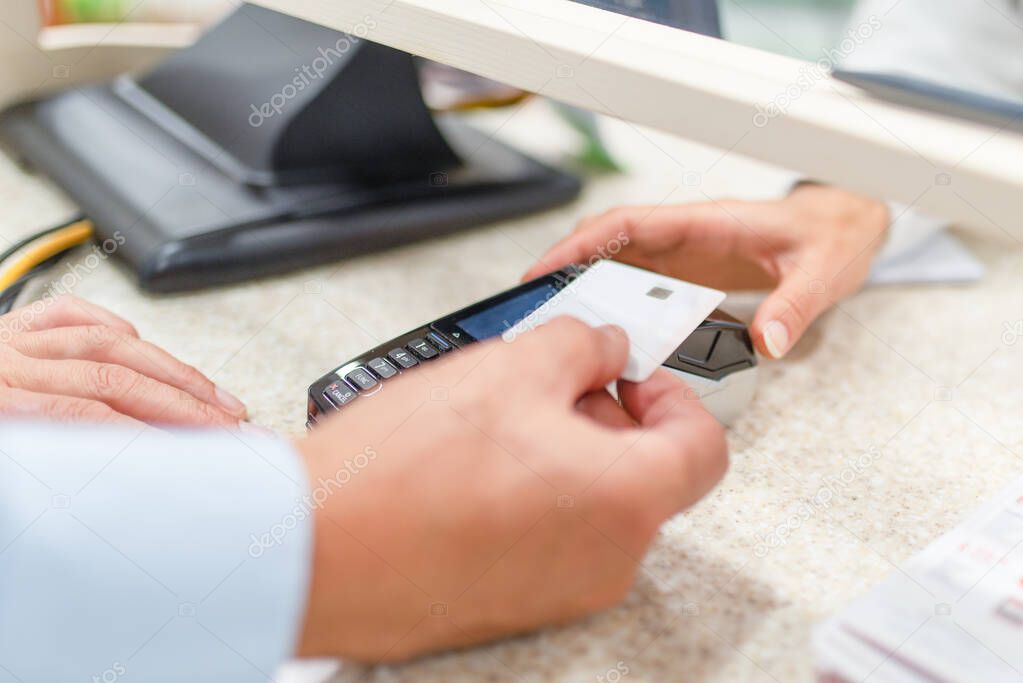 Detail of a customer paying by card in a pharmacy