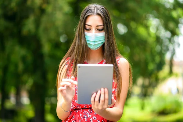 Mujer Joven Usando Una Tableta Digital Sentada Banco Parque Usando —  Fotos de Stock