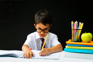 Kızgın akıllı okul öncesi veya ilk ilkokul çocuğu gözlükleri ile beyaz gömlekli