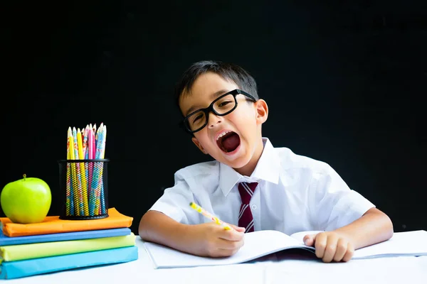 Smart preschool or first grade school boy in white shirt with eye glasses