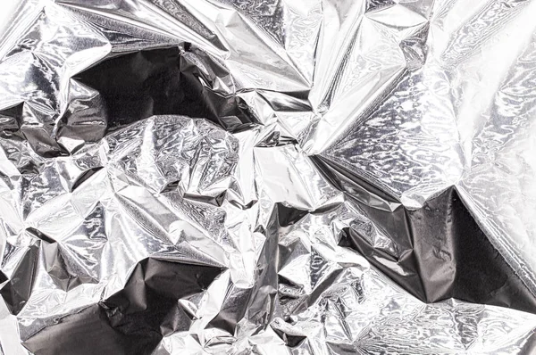 Crumpled metallic silver foil, shiny aluminum surface, abstract background