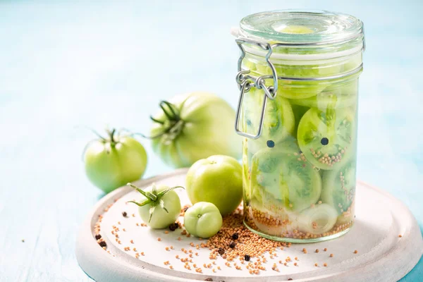 Fresh ingredients for pickled green tomatoes in the jar