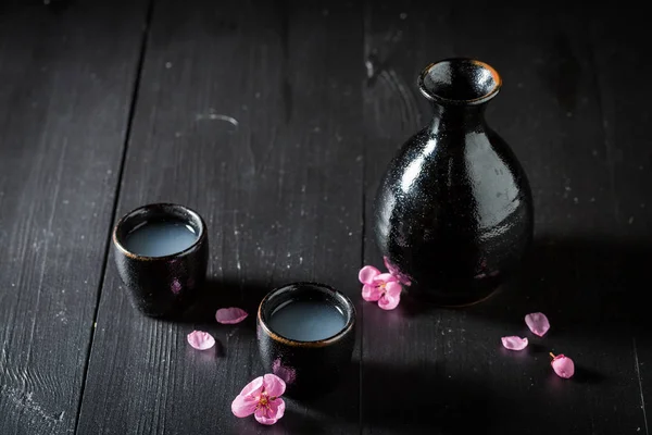 在黑暗的桌子上用黑色陶瓷清酒 — 图库照片