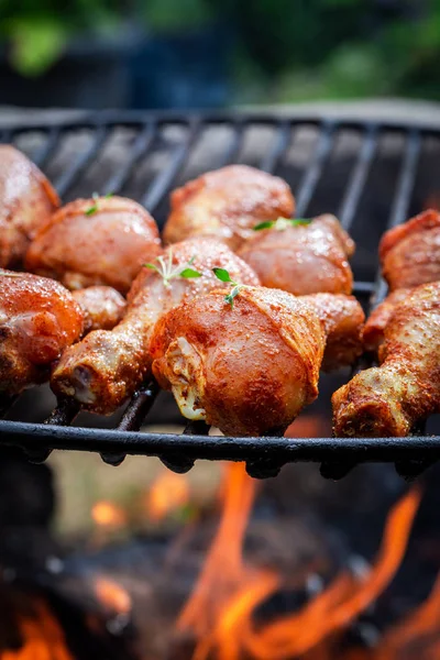 Tasty chicken leg on grill with spices — Stock Photo, Image