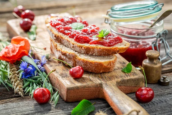 Closeup of sweet sandwich with fresh cherry jam — Stock Photo, Image