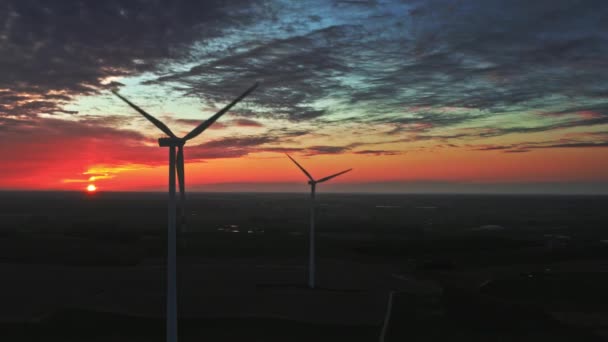 Sunset with wind turbines on farm field, aerial view — Stock Video