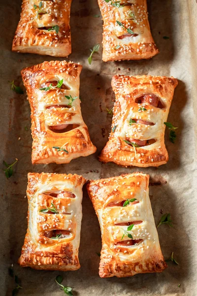 Homemade sausage in puff pastry with thyme and sesame seeds — Stock Photo, Image