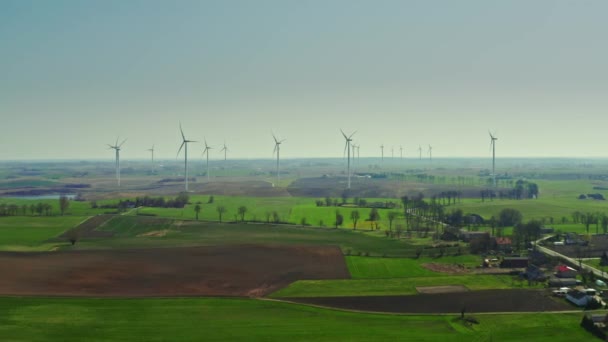 Farm of wind turbines on spring field in sunny day, Poland — Stock Video