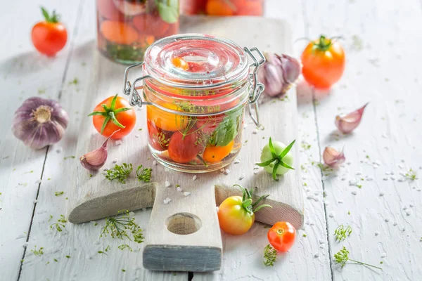 Preparation for canned red tomatoes on wooden table — Stock Photo, Image