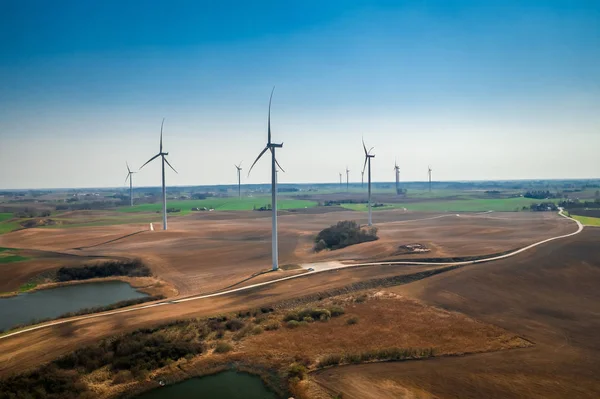 Aerial view of white wind turbines on brown field — Stock Photo, Image