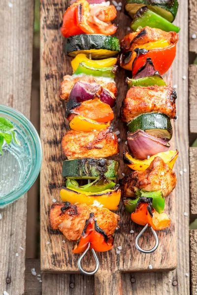 Pinchos picantes a la parrilla servidos con agua en verano — Foto de Stock