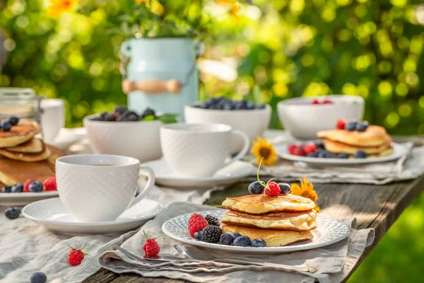 Leckere Pfannkuchen serviert mit Kaffee im Garten im Sommergarten — Stockfoto