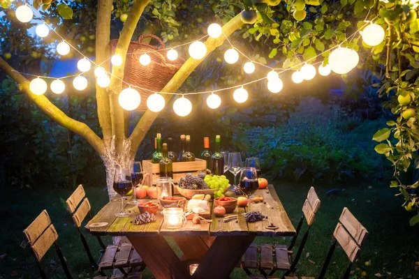 Supper with tasty appetizers and wine in summer evening — Stock Photo, Image