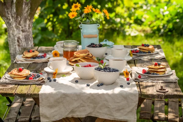Enjoy your pancakes for breakfast in summer garden — Stock Photo, Image