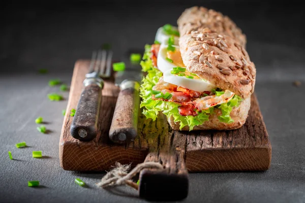 Sanduíche saboroso com ovos e alface, bacon — Fotografia de Stock